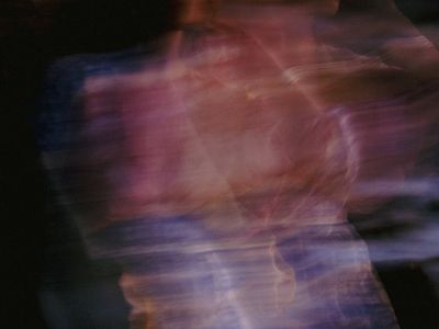 Abstract motion blur of a yoga pose.